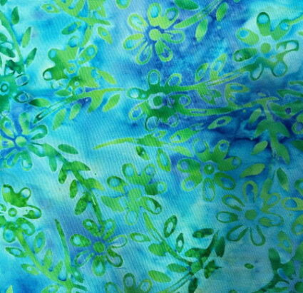 Nutex Batiks Oceania Green leaf and flower design on a turquoise fabric background