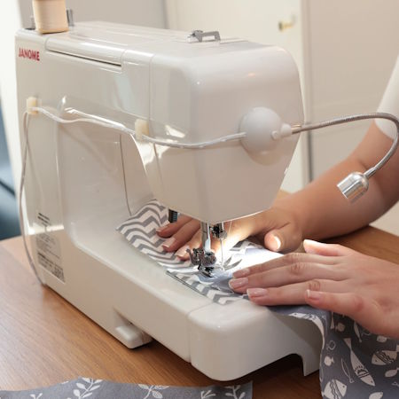 Sewing Machine Lamp by The Daylight Company with wires attached to the machine